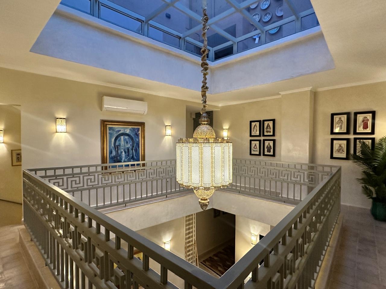 The patio seen from the upper gallery, with its ironwork balustrade and glass roof