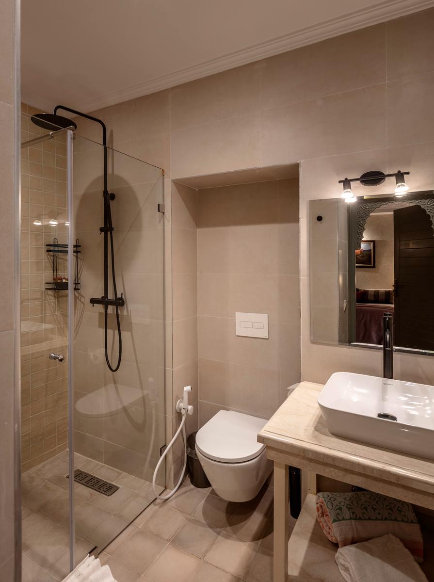 The Gallery Room's bathroom, with a walk-in shower and stone basin