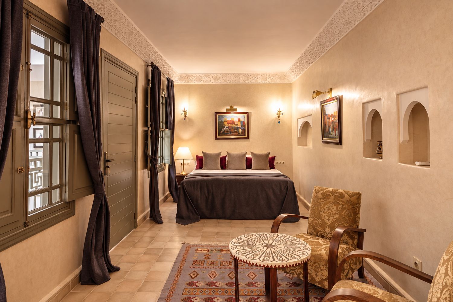 The Suite: a king bed with its own sitting area beneath a moulded plaster cornice