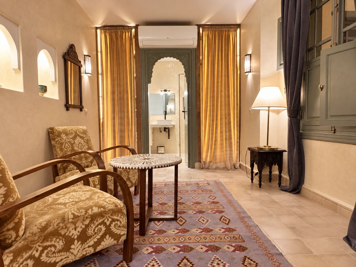 The Suite's sitting room, with armchairs and a Moroccan side table on a Berber rug